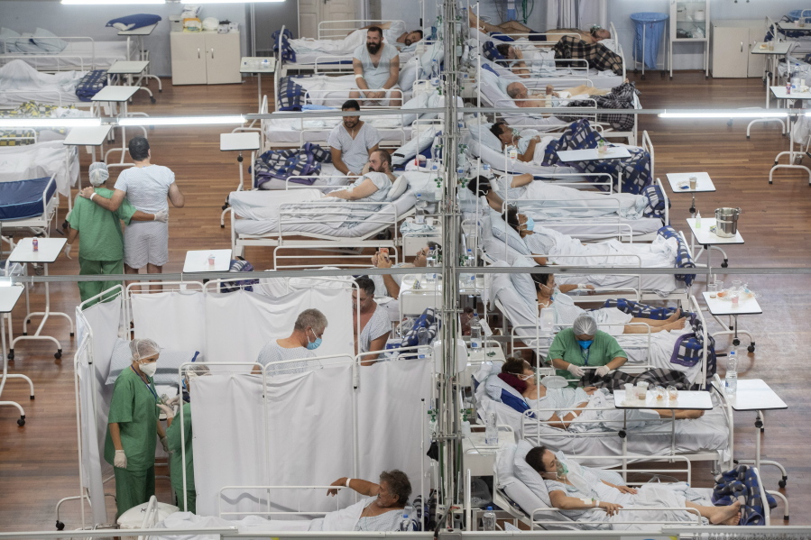 COVID-19 patients lie on beds at a field hospital built inside a sports coliseum in Santo Andre, on the outskirts of Sao Paulo, Brazil, Thursday, March 4, 2021.