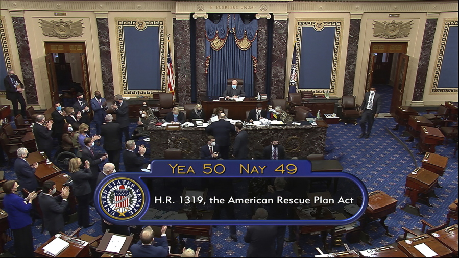 In this image from video, the vote total of 50-49 on Senate passage of the COVID-19 relief bill, is displayed on screen in the Senate at the U.S. Capitol in Washington, Saturday, March 6, 2021.