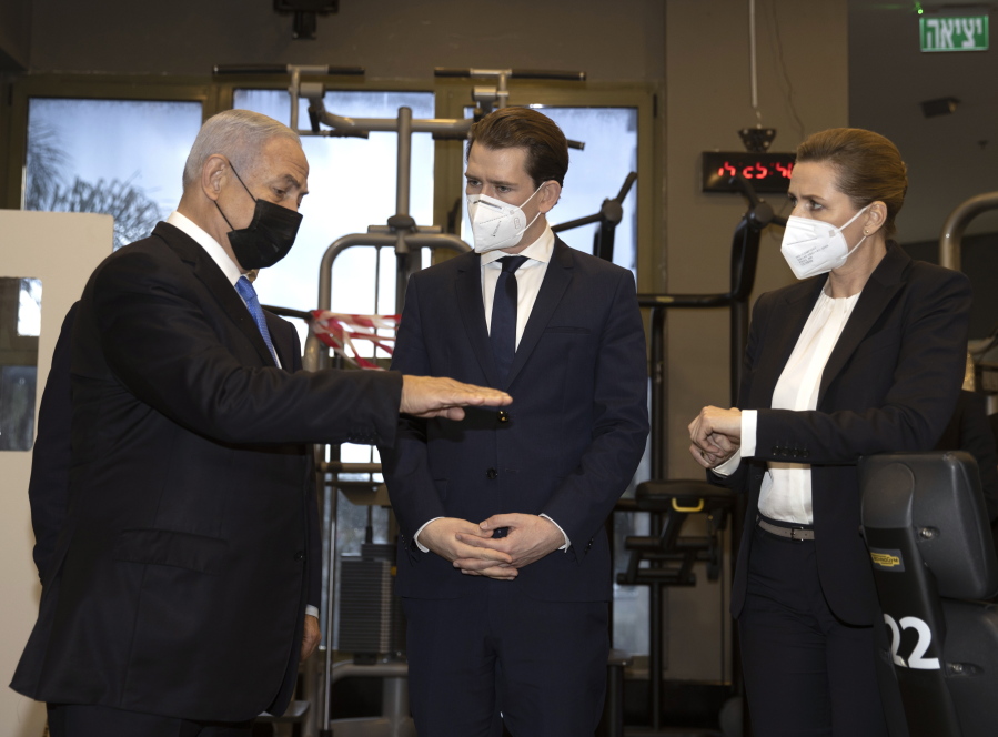 Israeli Prime Minister Benjamin Netanyahu, left, visits a fitness gym with Austrian Chancellor Sebastian Kurz, center, and Danish Prime Minister Mette Frederiksen, to observe how the &quot;Green Pass,&quot; for citizens vaccinated against COVID-19, is used, in Modi&#039;in, Israel, Thursday, March 4, 2021. Frederiksen and Kurz are on a short visit to Israel for to pursue the possibilities for closer cooperation on COVID-19 and vaccines.