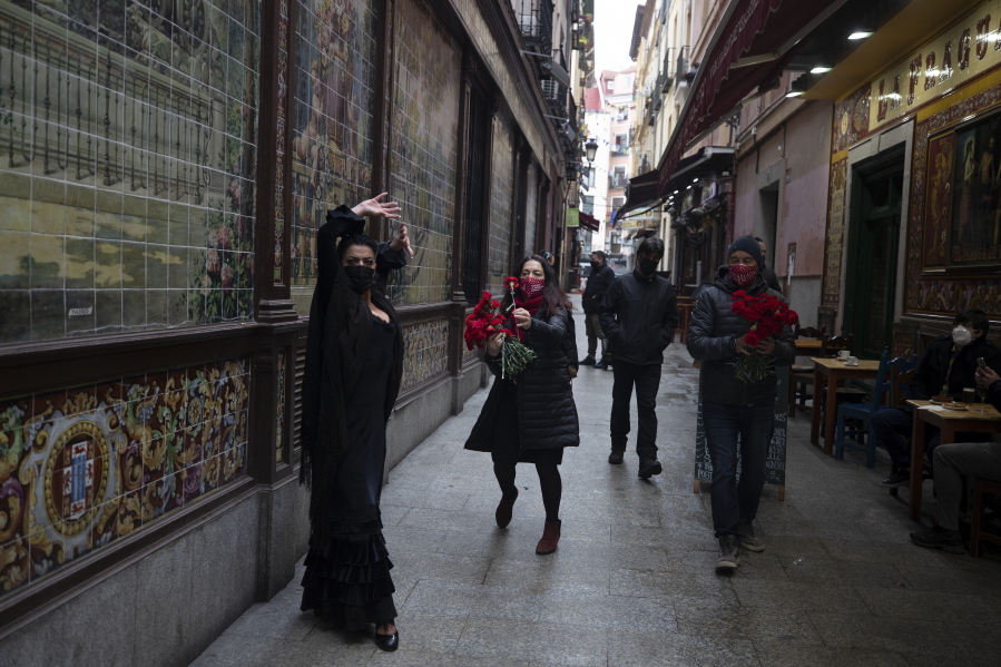 Spanish Flamenco dancer Anabel Moreno dances outside the Villa Rosa Tablao flamenco venue as a woman comes to give her a rose during a protest in Madrid, Spain, Thursday March 4, 2021. The National Association of Tablaos protested outside the mythical Villa Rosa Tablao which has been forced to close permanently due to the covid pandemic.