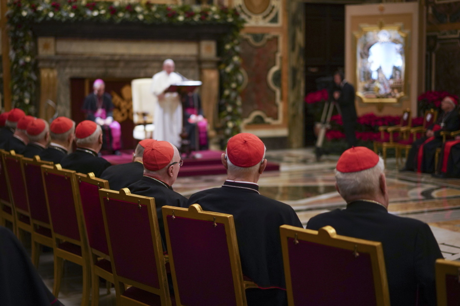 Cardinals listen Dec. 21, 2019, as Pope Francis, background, delivers his Christmas greetings to the Roman Curia, in the Clementine Hall at the Vatican.