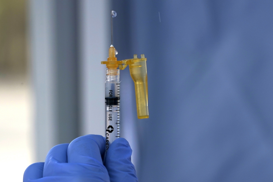 A syringe of the Moderna COVID-19 vaccine is shown Thursday, March 4, 2021, at a drive-up mass vaccination site in Puyallup, Wash., south of Seattle. Officials said they expected to deliver approximately 2500 second doses of the Moderna COVID-19 vaccine at the site Thursday. (AP Photo/Ted S.