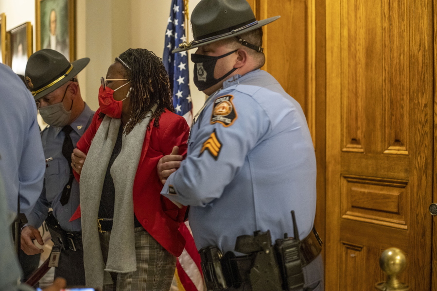 Georgia state Rep. Park Cannon, D-Atlanta, is placed in handcuffs by state troopers after being asked to stop knocking on a door that led to Gov. Brian Kemp&#039;s office while Kemp was signing the state&#039;s new voting law, SB 202, behind closed doors Thursday at the Georgia State Capitol Building in Atlanta.