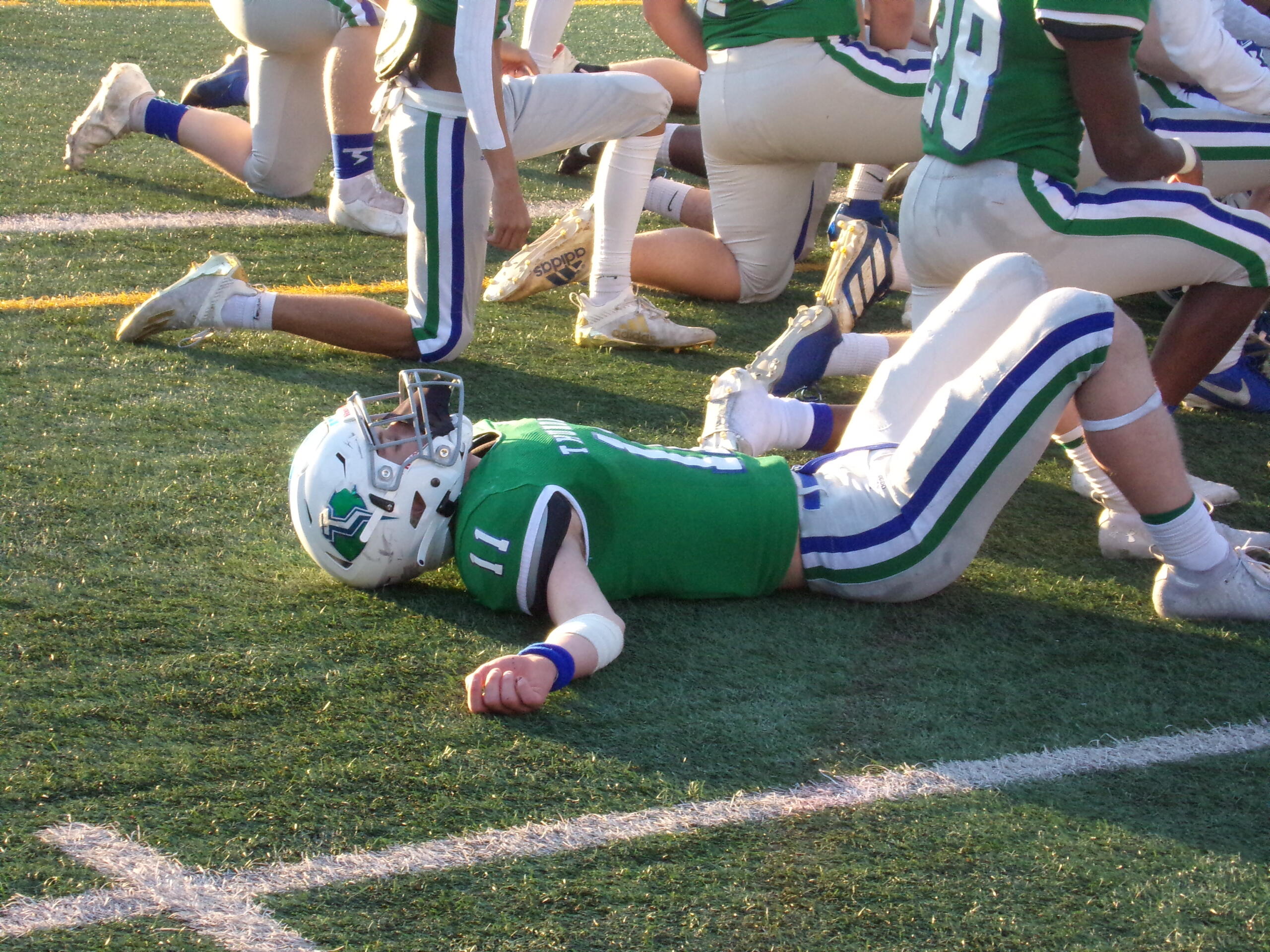 An exhausted Zak Gable lies on the McKenzie Stadium turf after Mountain View's 30-24 win in overtime against Prairie (Tim Martinez / The Columbian)