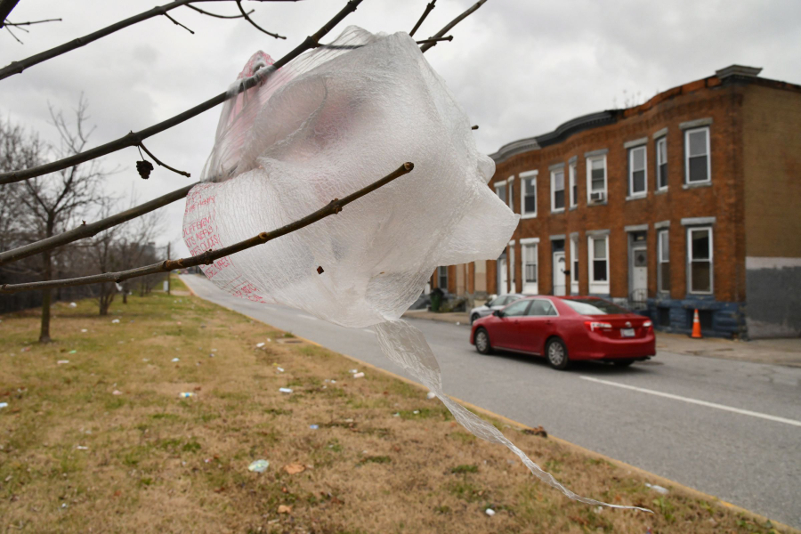 Bags and trash litter the grass border on West Mulberry Street above the Route 40 expressway. Baltimore City&#039;s ban on single-use plastic bags at supermarkets, restaurants and all other retail stores was going to take effect Jan. 13. Now it&#039;s July 14, due to the coronavirus pandemic.