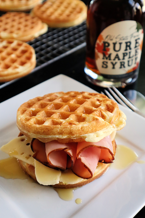 A drizzle of real maple syrup gives a ham and cheese waffle sandwich a sweet finish.