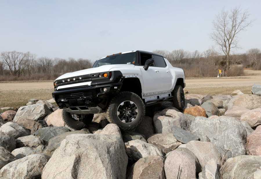 Christopher Stanek, the engineer behind the Ultravision system with underbody cameras on the Hummer EV, moves it off a pile of rocks at the General Motors Milford Proving Grounds in Milford, Mich., on Thursday, March 25, 2021.