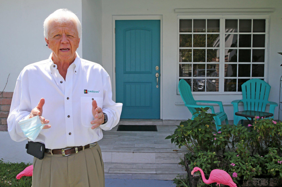 Don Cameron, owner of Hi-Land Properties, a We Buy Ugly Houses franchise based in South Florida, stands outside a Miami home on March 18, 2021.