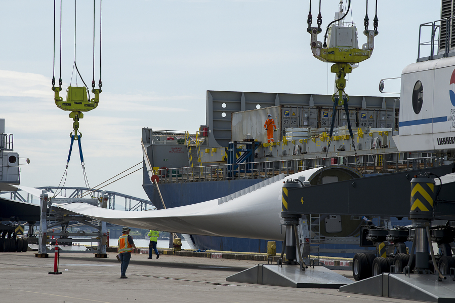 Workers unload wind blades bound for Canada from the MV Star Kilimanjaro at the Port of Vancouver on May 4, 2020. The ship departed China on April 13 and held 27 blades for nine wind turbines.