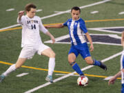 La Center's Angel Merino (10) dribbles past Seton Catholic's Dennis Babiy (14) during a Trico League matchup last week. Merino, an exchange student from Madrid, Spain, is receiving a truly American experience through high school sports.