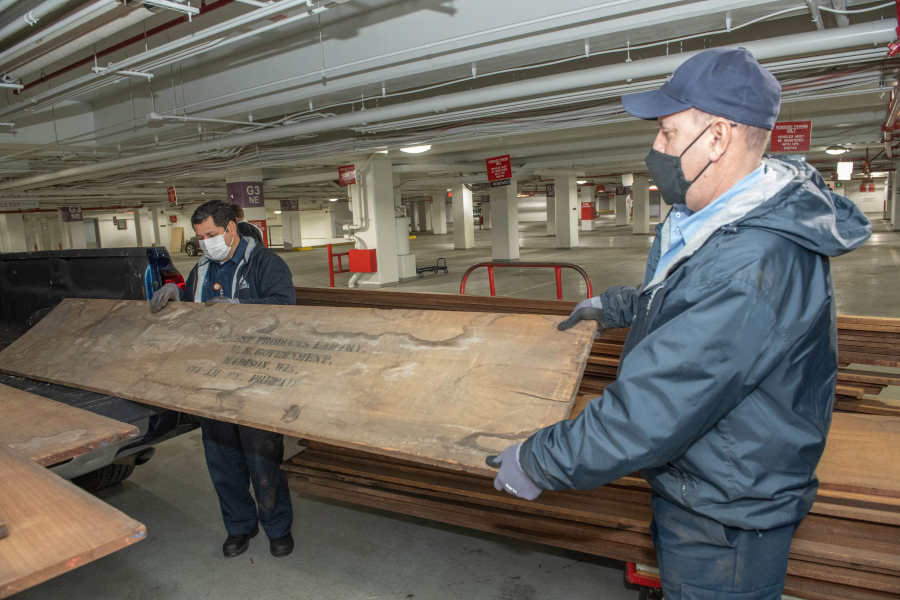 Architects of the Capitol staff hold rare century-old mahogany obtained from a U.S. Forest Service lab storage locker in Wisconsin. This historic mahogany lumber, received from USDA Forest Service's Forest Products Laboratory, will be used to replace U.S. Capitol doors and other wood details damaged during the January 2021 breach.
