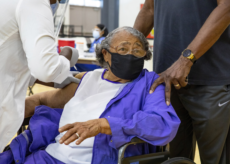 Former educator Nancy Dawkins, 97, who worked for Miami-Dade County Public Schools for more than 30 years, reacts to receiving a vaccine at the new FEMA-supported, state-run COVID-19 vaccine satellite site inside the Samuel K. Johnson Youth Center at Charles Hadley Park in Liberty City, Florida, on Friday, March, 19, 2021. (Daniel A.