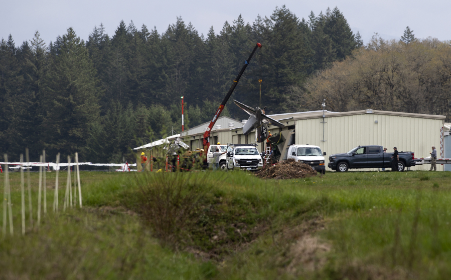 Crews work Thursday to remove a small plane that crashed into the far west hangar at Grove Field. A family member said Mark Lewallen of Vancouver died in the crash, while a second pilot providing instruction was seriously injured in the crash, which occurred around 3:15 p.m. Wednesday. The National Transportation Safety Board and Federal Aviation Administration were investigating the incident Thursday.