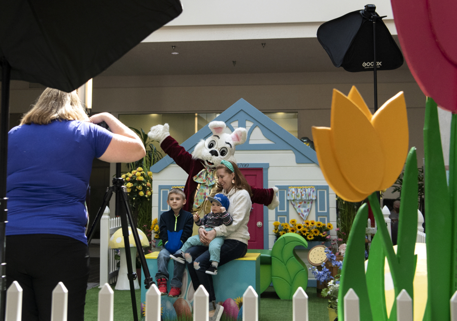 Melissa Brewer of 4Ever Photography snaps a shot of the Dees family - which includes 5-year-old Miles, 11-month-old Zane and mom Renee - with the Easter Bunny on Saturday at the Vancouver Mall.