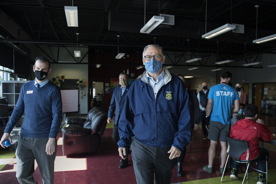 Francisco Bueno, executive director of the Boys &amp; Girls Clubs of Southwest Washington, joins Gov. Jay Inslee during a tour of the Teen Turf club Friday afternoon. Inslee&#039;s visit also included stops at Eleanor Roosevelt Elementary School and the Tower Mall vaccination site.