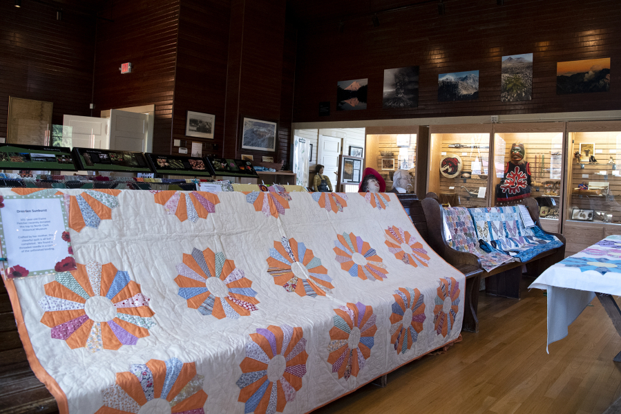 Quilts line the pews on Saturday at the North Clark Historical Museum in Amboy. This quilt pictured was recently donated by 101-year-old Elaine Fletcher. Her mother crafted the mostly finished quilt; a needle was found in the unfinished binding.