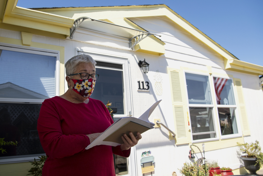 Claudette Derricotte, on April 21 at Cascade Park Estates, explains data of property values. Residents at the 55-and-older manufactured home community are voicing their dissatisfaction with the county's assessments of their units.