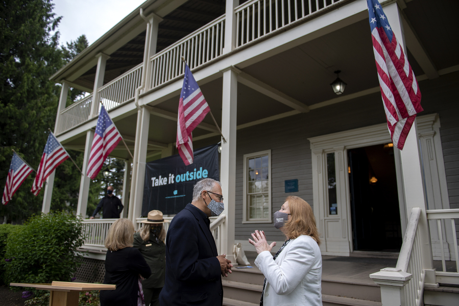 Gov. Jay Inslee talks with Mayor Anne McEnerny-Ogle following a press conference at the Grant House on Friday afternoon.