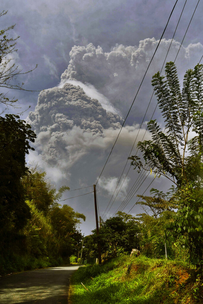 Plumes of ash rise from the La Soufriere volcano as it erupts on the eastern Caribbean island of St. Vincent, as seen from Chateaubelair, Friday, April 9, 2021.