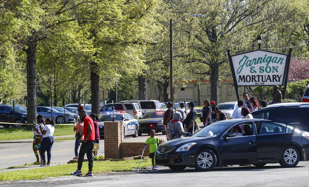 People gather outside Austin-East Magnet High School in Knoxville, Tenn., following a shooting at the school Monday, April 12, 2021.