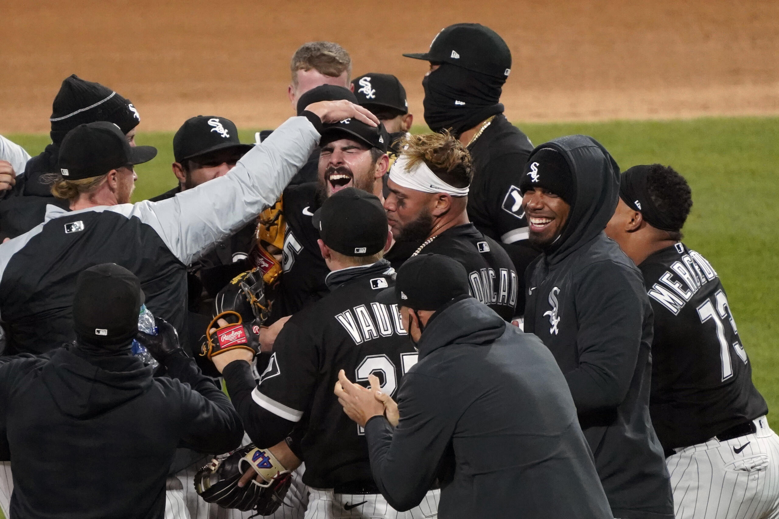 Chicago White Sox starting pitcher Carlos Rodon, center, celebrates his no hitter against the Cleveland Indians with his teammates in a baseball game, Wednesday, April, 14, 2021, in Chicago.