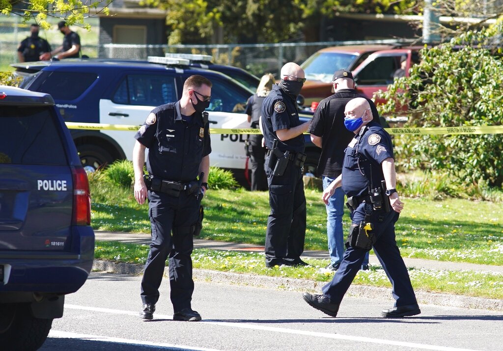 Law enforcement personnel work at the scene following a police involved shooting of a man at Lents Park, Friday, April 16, 2021, in Portland, Ore. Police fatally shot a man in the city park Friday morning after responding to reports of a person with a gun, authorities said.