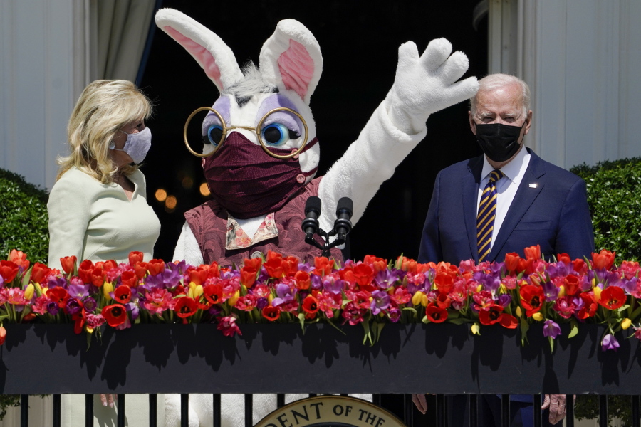 President Joe Biden appears with first lady Jill Biden and the Easter Bunny on the Blue Room balcony at the White House, Monday, April 5, 2021, in Washington. The annual Easter egg Roll at the White House was canceled due to the ongoing pandemic.