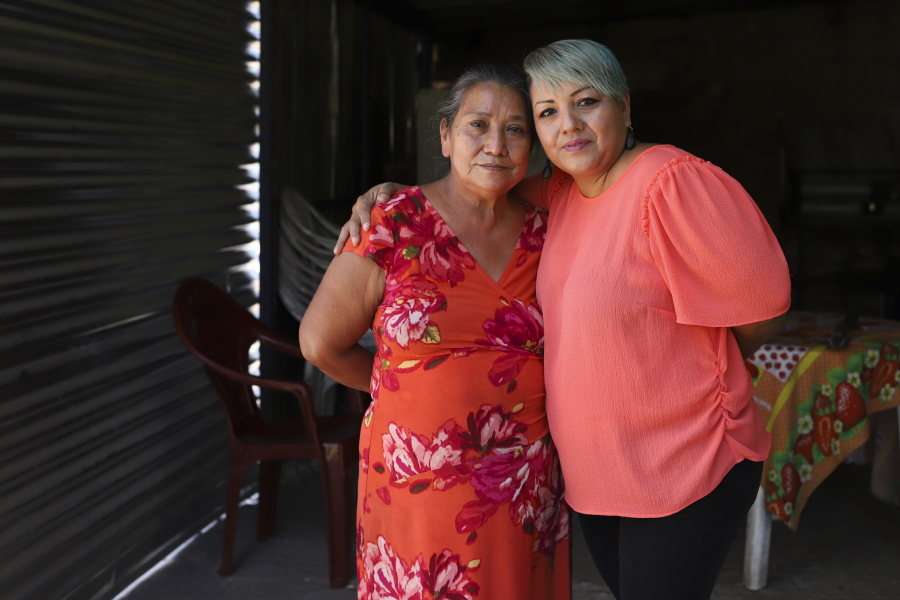 Iris Franco, right, hugs her mother, Elsa Victorina Franco, at her home, in El Ranchador, Santa Ana, El Salvador, Friday, March 5, 2021. The Salvadoran family lives humbly but is in a better place thanks to financial support from a family member in the United States who is part of the Temporary Protected Status program.