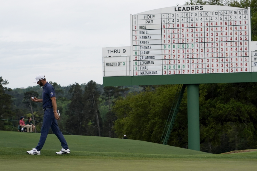 Dustin Johnson walks off the 18th green after his second round in the Masters golf tournament on Friday, April 9, 2021, in Augusta, Ga. (AP Photo/David J.