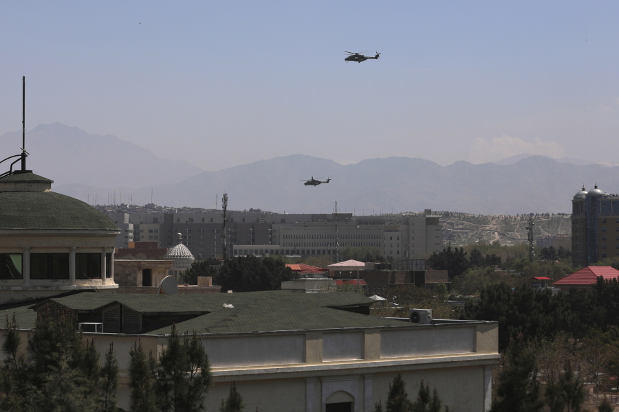 U.S. Black Hawk military helicopters fly over the city of Kabul, Afghanistan, Monday, April 19, 2021.