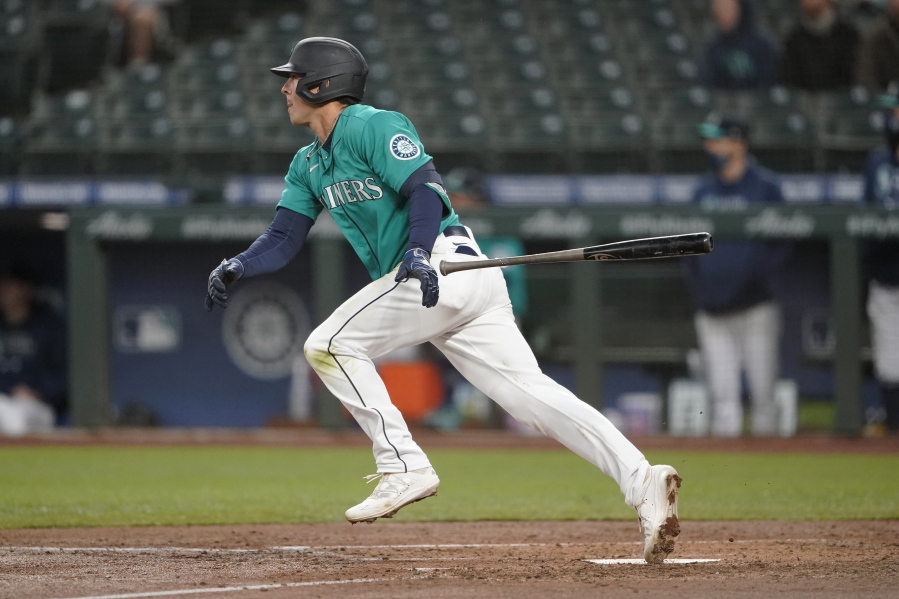 Seattle Mariners' Dylan Moore watches his RBI single during the third inning of the team's baseball game against the Los Angeles Angels, Friday, April 30, 2021, in Seattle. (AP Photo/Ted S.