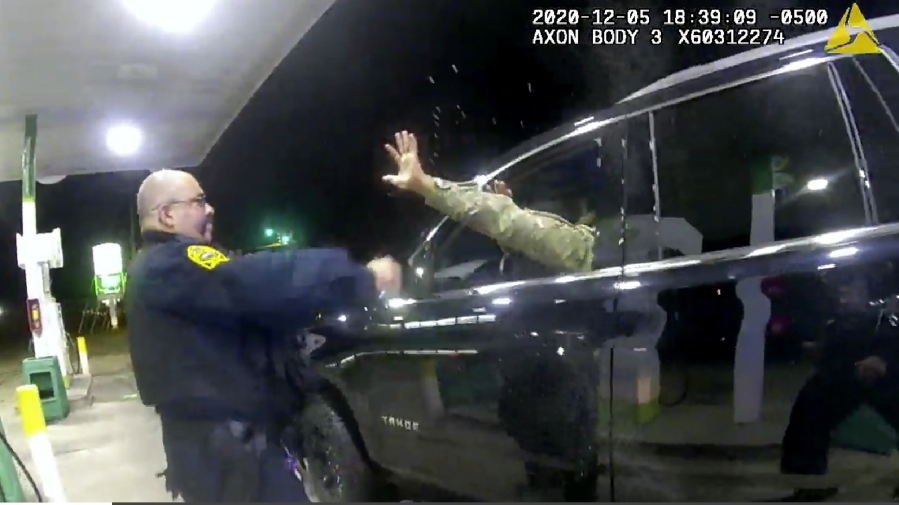 In this image made from Windsor, (Va.) Police video, A police officer uses a spray agent on Caron Nazario on Dec. 20, 2020, in Windsor, Va.  Nazario, a second lieutenant in the U.S. Army, is suing two Virginia police officers over a traffic stop during which he says the officers drew their guns and pointed them at him as he was dressed in uniform. Caron Nazario says his constitutional rights were violated by the traffic stop in the town of Windsor in December.