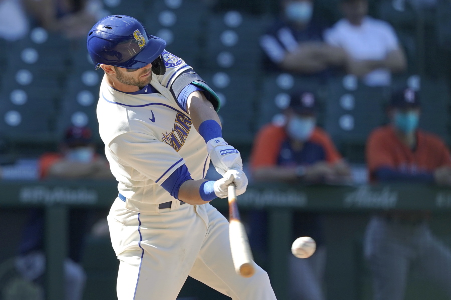 Seattle Mariners' Mitch Haniger hits an RBI-double during the seventh inning of a baseball game against the Houston Astros, Sunday, April 18, 2021, in Seattle. (AP Photo/Ted S.