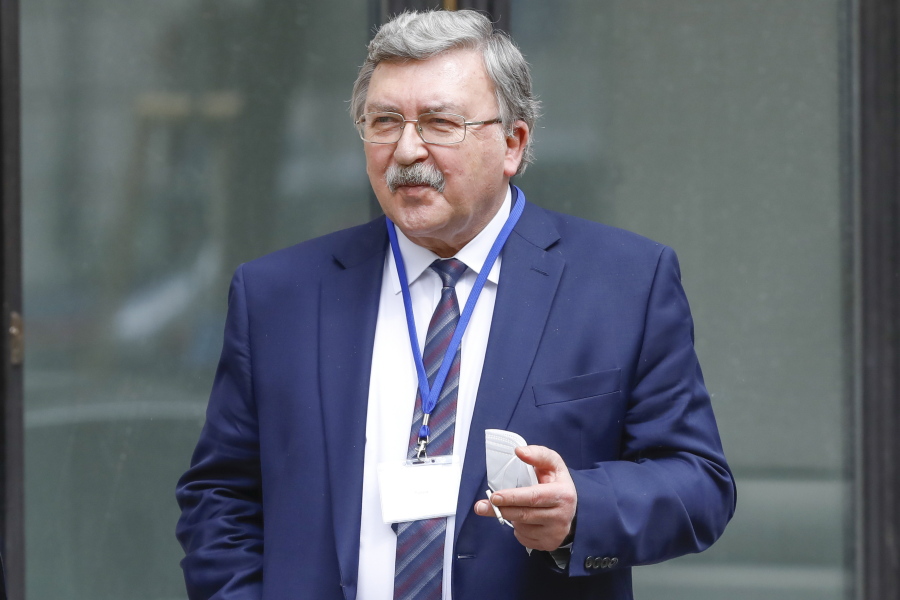 FILE - In this April 20, 2021 file photo Russia's Governor to the International Atomic Energy Agency, IAEA, Mikhail Ulyanov smokes a cigarette in front of the 'Grand Hotel Wien' where closed-door nuclear talks with Iran take place in Vienna, Austria.