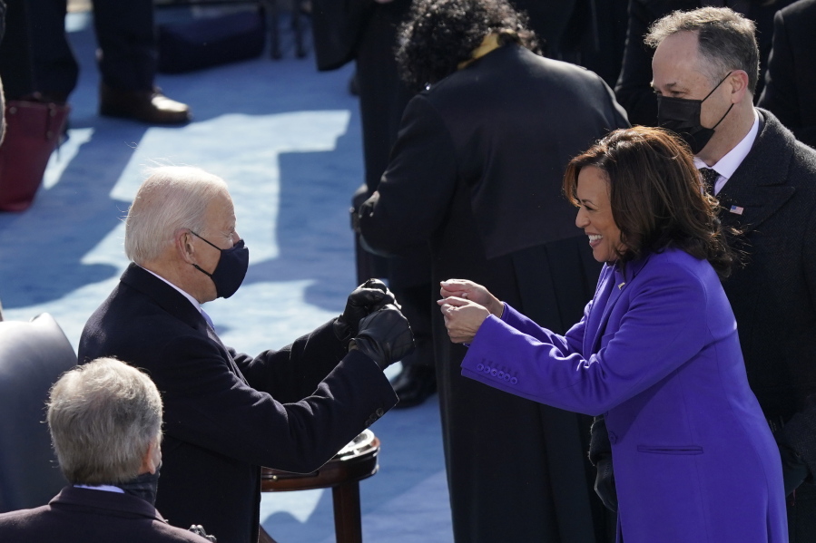 FILE - In this Jan. 20, 2021, file photo President-elect Joe Biden congratulates Vice President Kamala Harris after she was sworn in during the 59th Presidential Inauguration at the U.S. Capitol in Washington. Biden will mark his 100th day in office on Thursday, April 29.