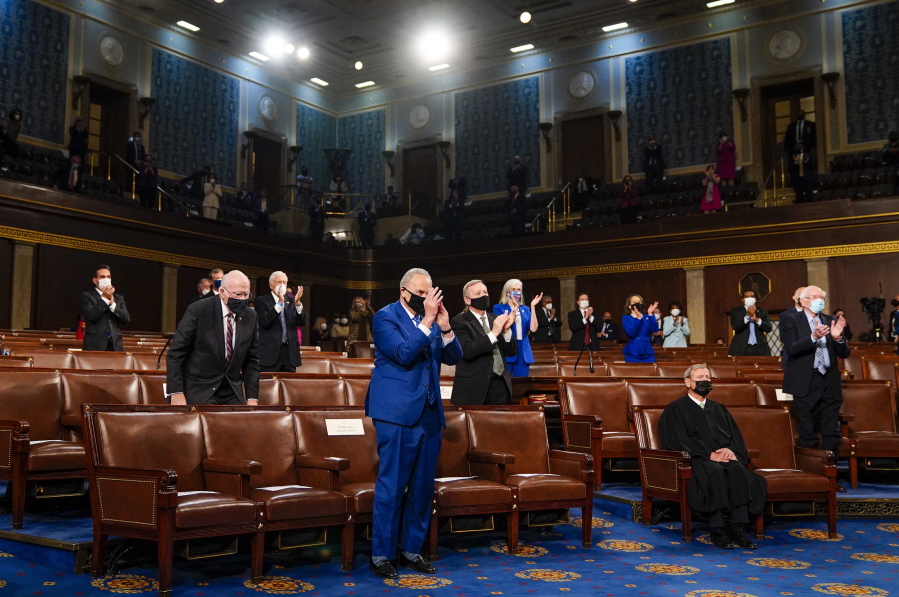 Senate Majority Leader Chuck Schumer of N.Y., stands and applauds as President Joe Biden addresses a joint session of Congress, Wednesday, April 28, 2021, in the House Chamber at the U.S. Capitol in Washington.