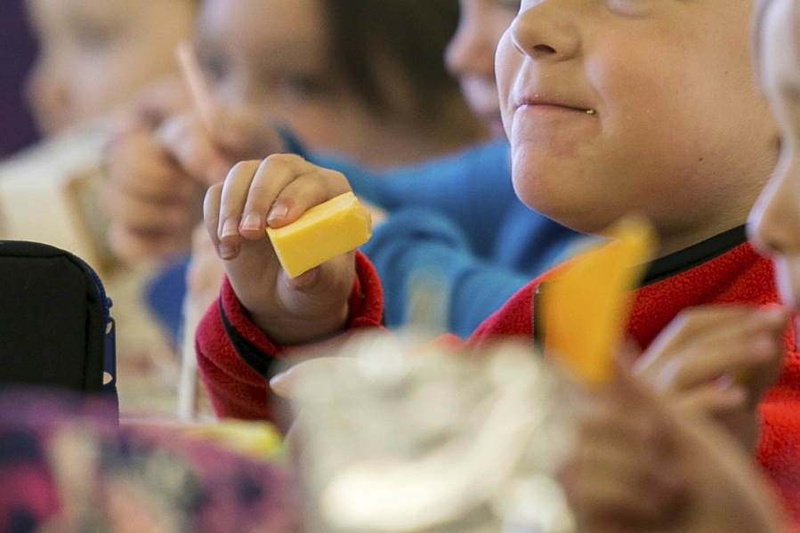 FILE - In this Monday, Oct. 29, 2018, file photo, kids eat lunch at an elementary school in Paducah, Ky. The Biden administration is expanding a program to feed as many as 34 million school children during the summer months. They're using funds from the coronavirus relief package approved in March 2021.