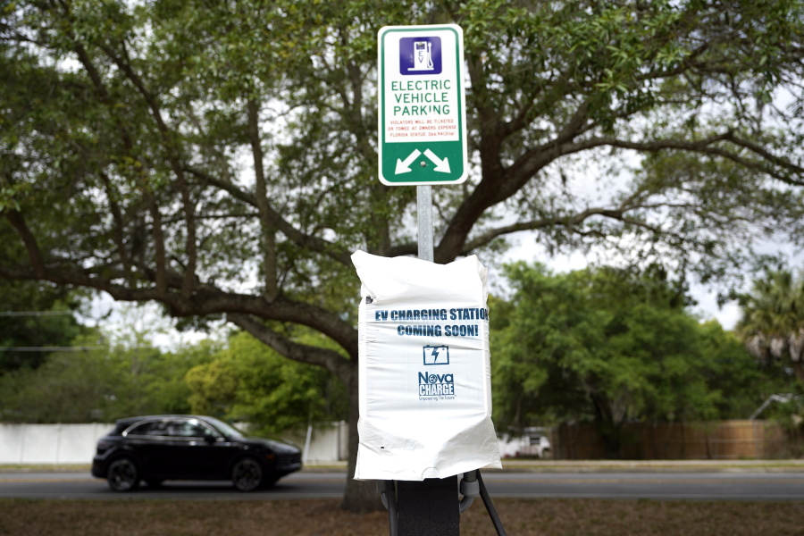 A parking area with charging stations for electric vehicles at a public park is seen Thursday, April 1, 2021, in Orlando, Fla. As part of an infrastructure proposal by the Biden administration, $174 billion will be set aside to build 500,000 electric vehicle charging stations, electrify 20% of school buses and electrify the federal fleet, including U.S.