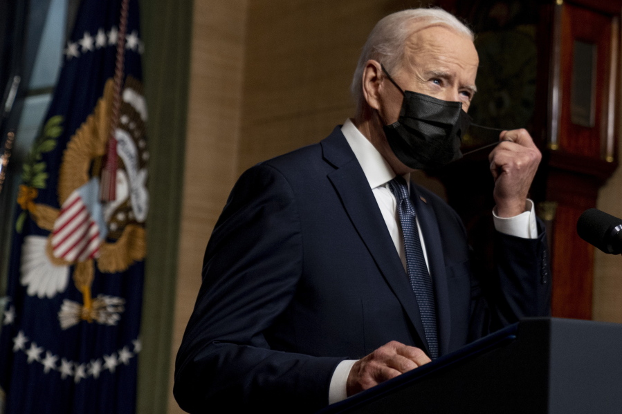 FILE - In this Wednesday, April 14, 2021, file photo, President Joe Biden removes his mask to speak at a news conference at the White House, in Washington. Ten liberal senators are urging Biden to back India and South Africa's appeal to the World Trade Organization to temporarily relax intellectual property rules so coronavirus vaccines can be manufactured by nations that are struggling to inoculate their population.