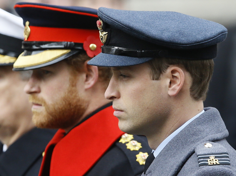 FILE - In this Sunday Nov. 8, 2015 file photo, Britain's Prince William, right, and Prince Harry attend the Remembrance Sunday ceremony at the Cenotaph in London. Senior royals must wear civilian clothes to Prince Philip's funeral, defusing potential tensions over who would be allowed to don military uniforms. Queen Elizabeth II's decision means Prince Harry won't risk being the only member of the royal family not in uniform during the funeral on Saturday April 17, 2021 for his grandfather, who died last week at the age of 99.