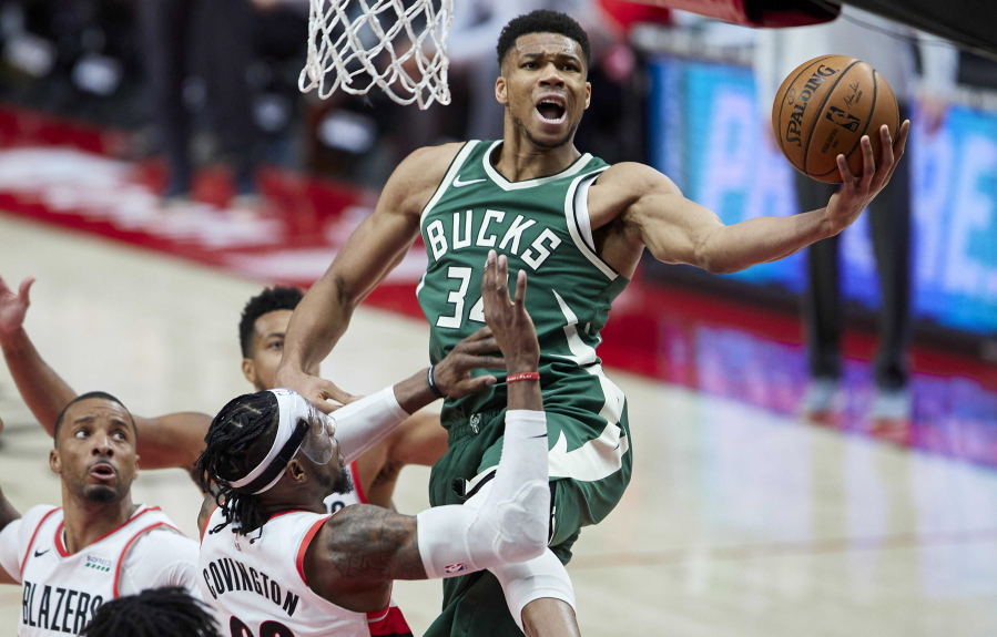 Milwaukee forward Giannis Antetokounmpo, right, drives to the basket against the Portland Trail Blazers on Friday.