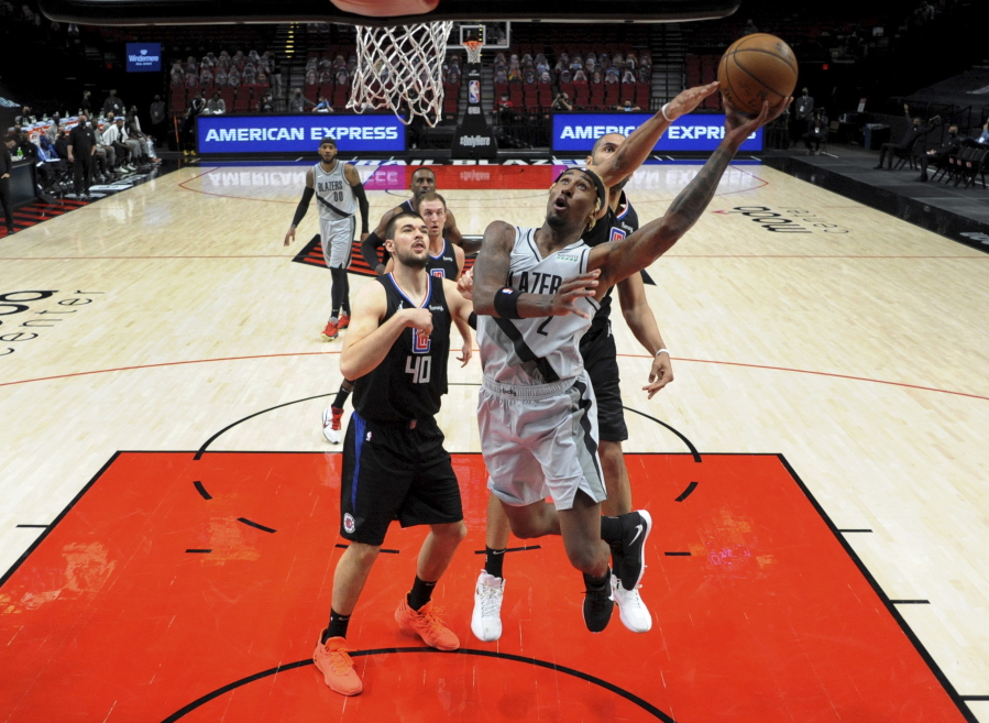Portland Trail Blazers forward Rondae Hollis-Jefferson, right, drives to the basket on Los Angeles Clippers center Ivica Zubac, left, during the first half of an NBA basketball game in Portland, Ore., Tuesday, April 20, 2021.