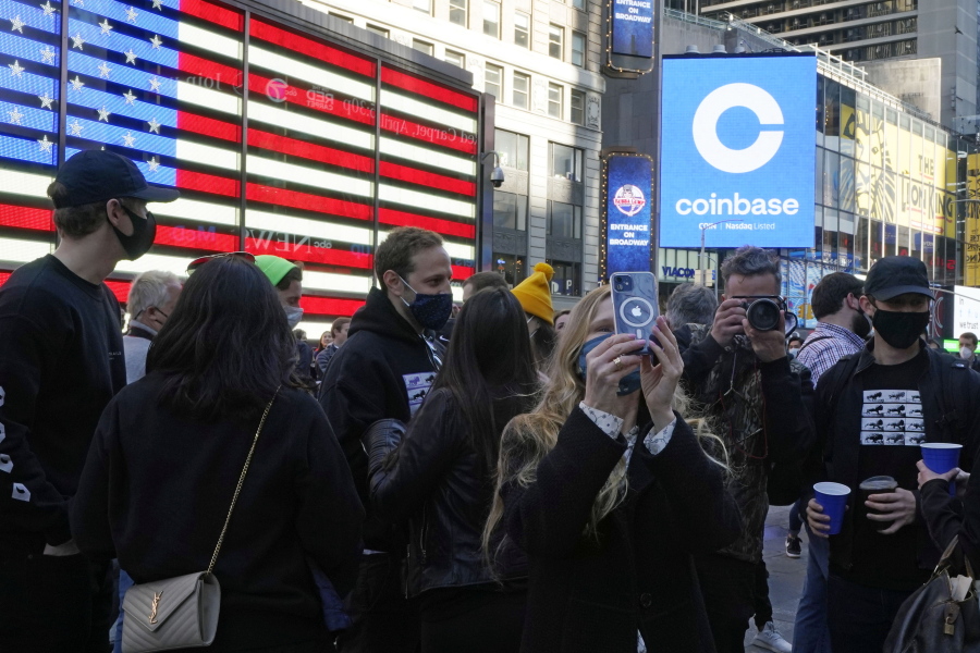 Coinbase employees gather outside the Nasdaq MarketSite during the company&#039;s IPO, in New York&#039;s Times Square, Wednesday, April 14, 2021. Wall Street will be focused on Coinbase Wednesday with the digital currency exchange becoming a publicly traded company.