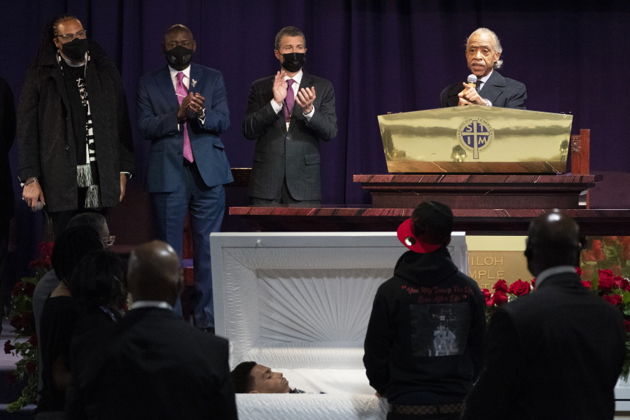 The Rev. Al Sharpton, right, speaks over the casket of Daunte Wright, alongside attorneys Antonio Romanucci, center, and Ben Crump, center left, and the Rev. Greg Drumwright, left, Wednesday, April 21, 2021, in Minneapolis. The 20-year-old Wright was killed by former Brooklyn Center police Officer Kim Potter during a traffic stop.