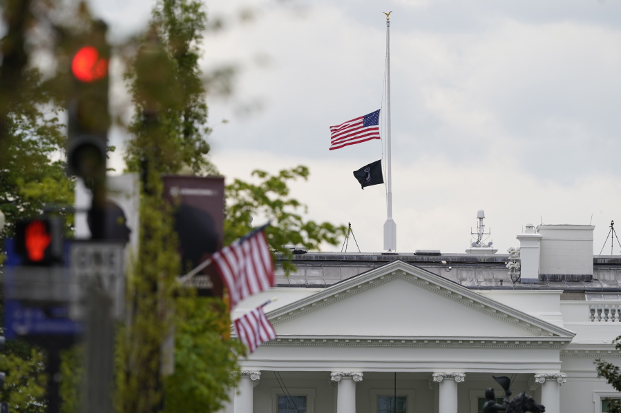 The American flag flies at half-staff over the White House in Washington, Friday, April 16, 2021.