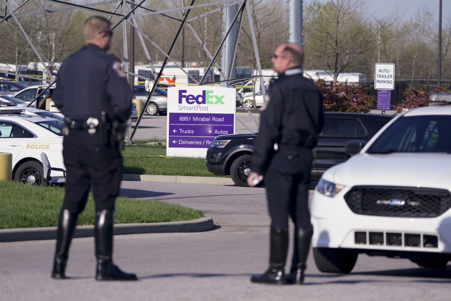 Authorities confer at the scene where multiple people were shot at the FedEx Ground facility early Friday morning, April 16, 2021, in Indianapolis. A gunman killed eight people and wounded several others before apparently taking his own life in a late-night attack at a FedEx facility near the Indianapolis airport, police said, in the latest in a spate of mass shootings in the United States after a relative lull during the pandemic.