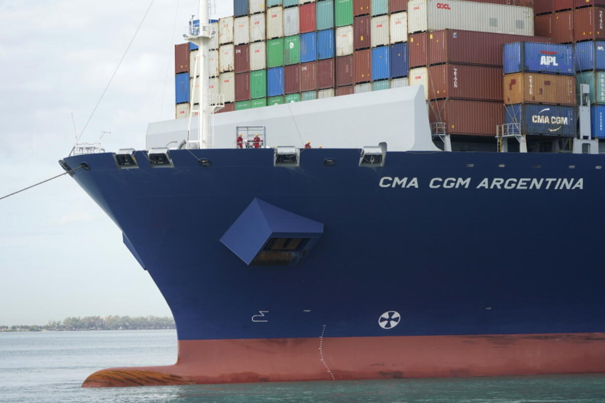 Crew members stand on the bow as the CMA CGM Argentina arrives at PortMiami, the largest container ship to call at a Florida port, Tuesday, April 6, 2021, in Miami.  The U.S. trade deficit grew to $71.1 billion in February, as a decline in exports more than offset a slight dip in imports. The February gap between what America buys from abroad compared to what it sells abroad jumped 4.8% the revised January deficit of $67.8 billion.vThe increase reflected a 2.6% decline in exports of goods and services to $187.3 billion on a seasonally adjusted basis.