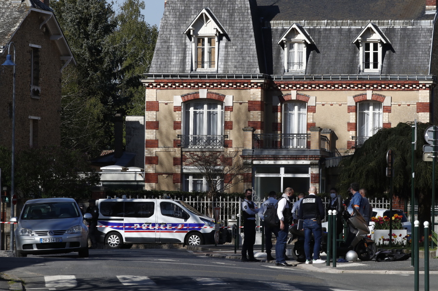 Police officers gather next to the Police station in Rambouillet, south west of Paris, Friday, April 23, 2021. A French police officer was stabbed to death inside her police station Friday near the famed historic Rambouillet chateau, and her attacker was shot and killed by officers at the scene, authorities said. The identity and the motive of the assailant were not immediately clear, a national police spokesperson told The Associated Press. The police officer was a 49-year-old administrative employee in the station, the spokesperson said.