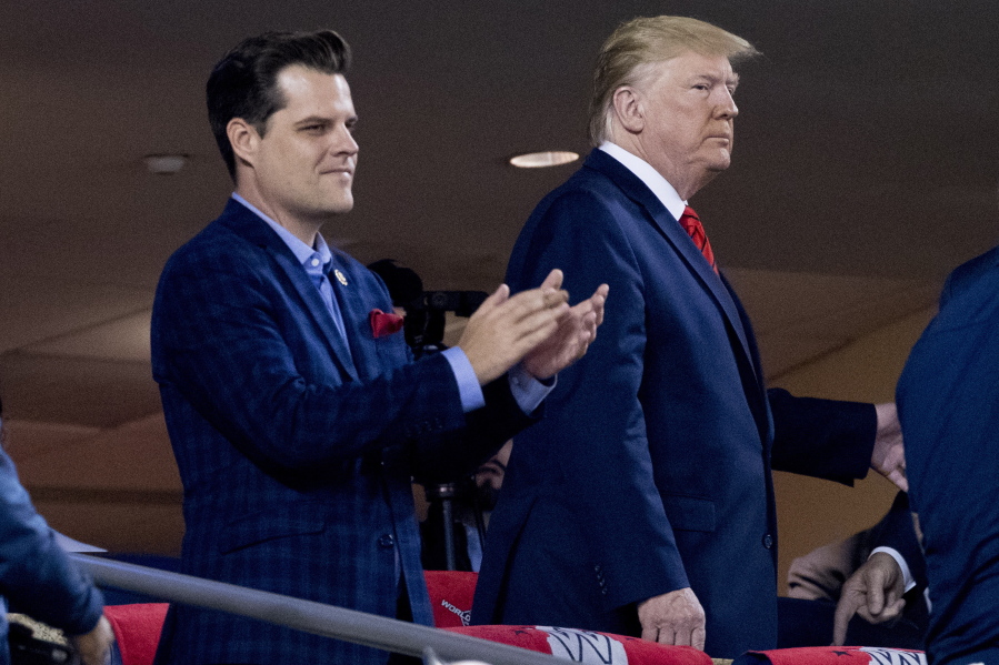 FILE - In this Oct. 27, 2019, file photo President Donald Trump, right, accompanied by Rep. Matt Gaetz, R-Fla., left, arrive for Game 5 of the World Series baseball game between the Houston Astros and the Washington Nationals at Nationals Park in Washington.