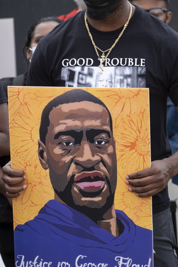 A person holds a poster of George Floyd on Tuesday in Atlanta.